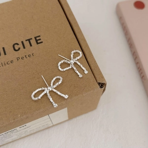 Minimalist 925 sterling silver bow knot stud earrings with woven texture on paper box
