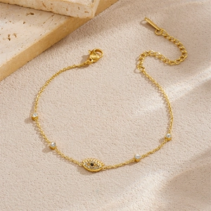 Elegante bracciale in acciaio inossidabile placcato oro con charm occhio e cristalli