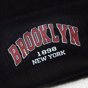 Detail of Brooklyn 1898 New York vintage typography on black ribbed knit beanie