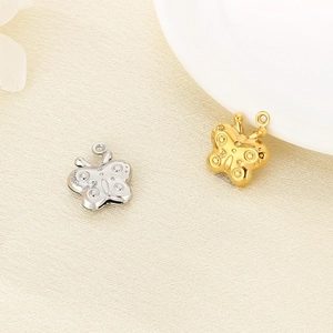 Detailed view of 3D hollow butterfly pendants in gold and silver stainless steel
