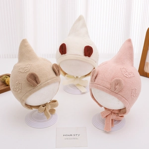 Three-pack of knitted baby hats with heart textures and cute ears for winter warmth