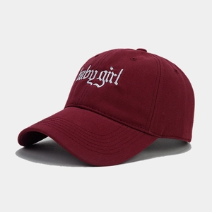 Detailed close-up of Babygirl gothic embroidery on burgundy cotton baseball cap