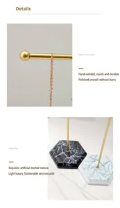 Detail of bold gold iron jewelry stand with white and black marble texture base