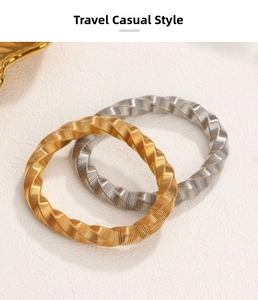 Macro shot of twisted ribbed metal bangles in gold and silver finish with detailed texture