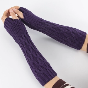 Close-up of purple knit arm warmers featuring classic cable stitch pattern and fingerless design