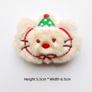 Detail view of plush cat head accessory with green polka dot Christmas hat 5.5x6.5cm