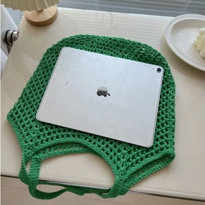Green crochet woven tote bag with a spacious interior showing a tablet for size reference