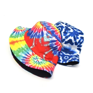 Tie-dye reversible bucket hats in vibrant rainbow and blue-white cloud patterns