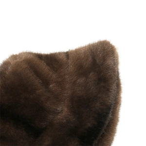 Macro shot of thick dark brown faux fur texture on a warm winter bucket hat for women