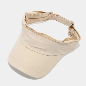Close-up of beige sun hat featuring functional zipper detail and breathable fabric