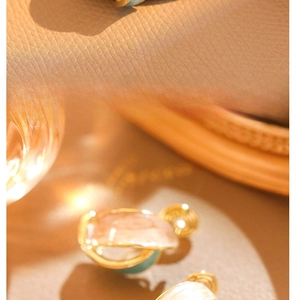Detailed macro shot of vintage French enamel clip-on earrings in gold and blue finish