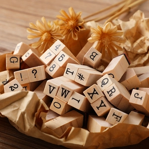 Retro wooden stamps set featuring alphabet letters and numbers on kraft paper background