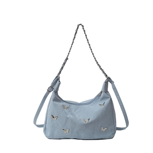Minimalist light blue crossbody bag with silver butterfly patches and chain strap