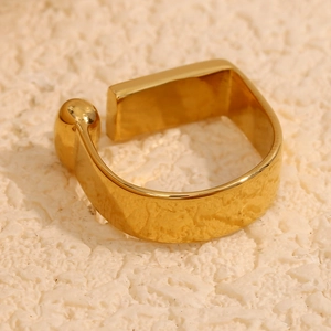 Macro detail of 18K gold-plated geometric ring with flat bar and sphere design