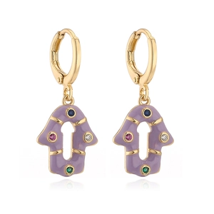 Detailed macro view of gold-plated Hamsa Hand hoop earrings with purple enamel and gems