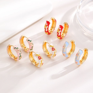 Detail of colorful floral enamel hoop earrings in red, pink, white and light blue hues