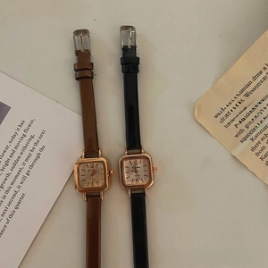 Detail of square vintage women watches with brown and black leather straps in retro style