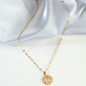 Elegant gold Sagittarius pendant necklace with cubic zirconia on satin background