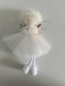 Detail of white Christmas angel doll with tulle skirt and silver tinsel wings for tree decoration