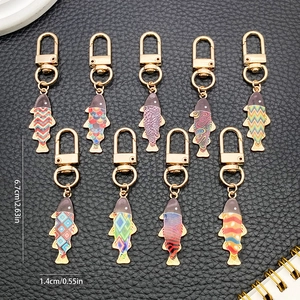 Detail showing dimensions of fish-shaped enamel keychains with golden D-rings