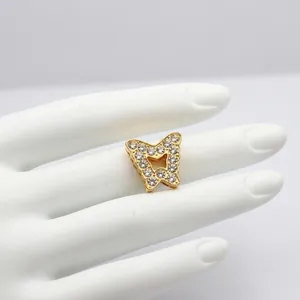 Close-up of gold butterfly charm with sparkling crystals for DIY 10mm slide bracelets