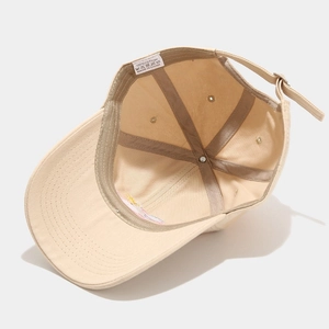 Beige cotton baseball cap interior detail with adjustable strap and stitched seams