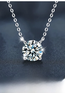 Close-up of S925 sterling silver necklace featuring a four-claw moissanite pendant