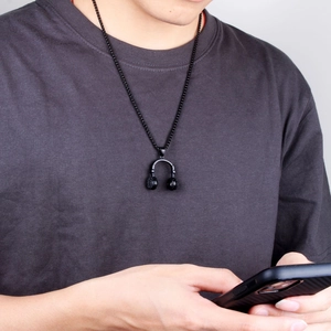 Hip hop black headphone pendant necklace in vintage punk style on male model