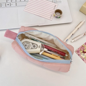 Detailed view of large capacity quilted soft pencil case showing pens and stationery inside