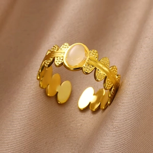 Detailed view of vintage gold ring with oval opal stone and intricate flower engravings