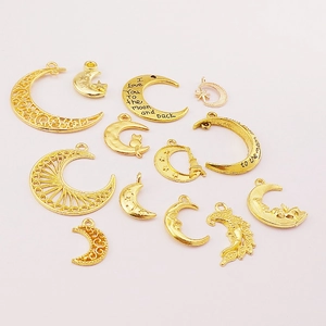 Golden moon alloy pendants with I love you to the moon and back engraving on white surface