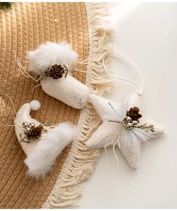 Detailed view of plush Christmas ornaments with faux fur, pine cones and silver accents