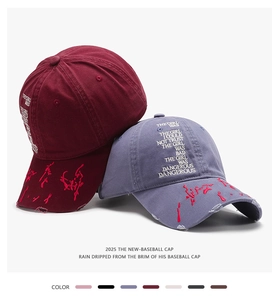 Close-up of vintage washed cotton baseball caps with detailed letter embroidery and distressed brim