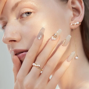 Close-up of elegant gold s925 silver ring and tassel earrings with freshwater pearls