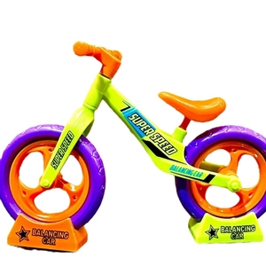 Miniature toy balance bike in yellow-green and orange colors, high-detail studio shot