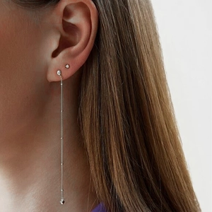 Close-up of minimalist S925 silver long chain tassel earrings with geometric charms