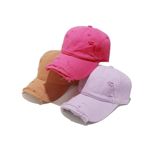 Vintage distressed baseball caps in pink, purple and khaki with ripped detailing