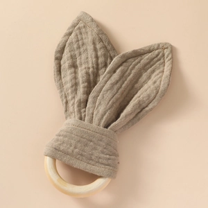 Soft muslin cotton bunny ear teether with a natural wooden ring detail for infants