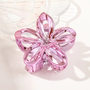 Detail view of the pink metallic frangipani flower hair claw clip with glossy finish