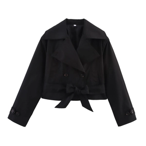 Close-up of black double-breasted trench coat showing the belt and lapel detail