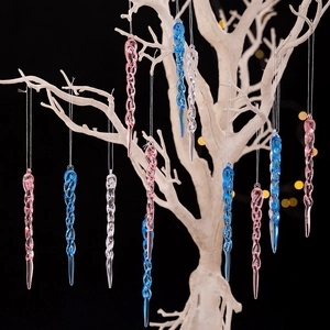 Macro detail of twisted acrylic Christmas icicle ornaments in pink blue and clear colors