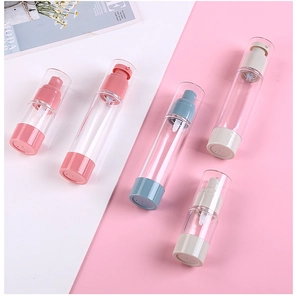 Flat lay of pink, blue, and beige refillable cosmetic spray bottles on a clean background