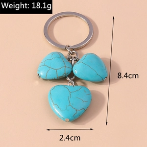 Macro view of triple turquoise heart charms keychain with precise size dimensions