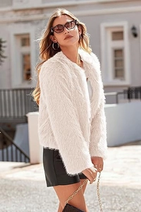 Detailed close-up showing soft texture and fluffy white faux fur fabric of women jacket