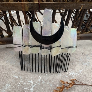 Detail of handcrafted black metal hair comb featuring iridescent crystals and moon charm