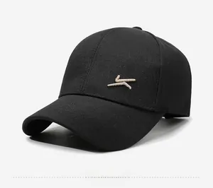 Detail of a black cotton baseball cap showing white embroidery and six-panel structure