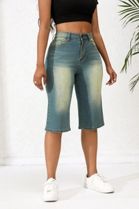Detailed shot of retro blue high-waist denim Bermuda shorts with whiskered washing details