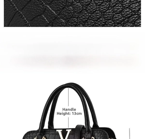 Detail view of black embossed leather handbag with gold V logo and 13cm handle height