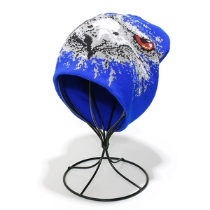 Detailed knit texture of royal blue winter beanie with eagle monster eye jacquard pattern