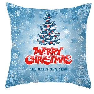 Detail of Christmas pillow cover with blue snowflake pattern and festive holiday greeting